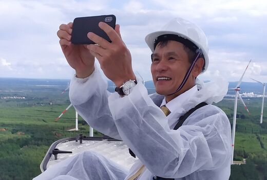 Man with smartphone on wind turbine at Klettwitz wind farm